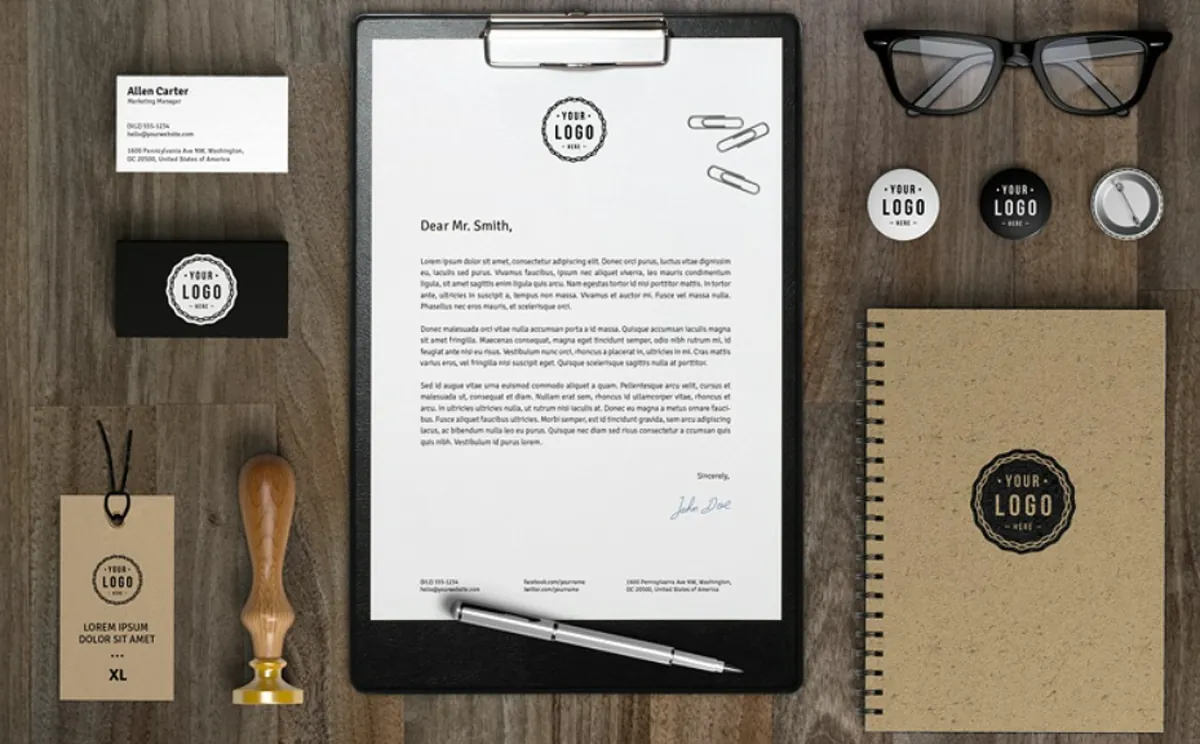 Branded stationery set: business cards, letterhead, tags and notebook laid out on a desk